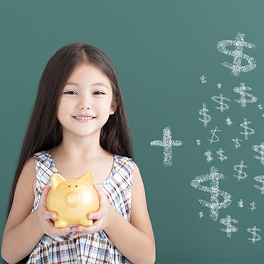 Young girl holding a piggy bank