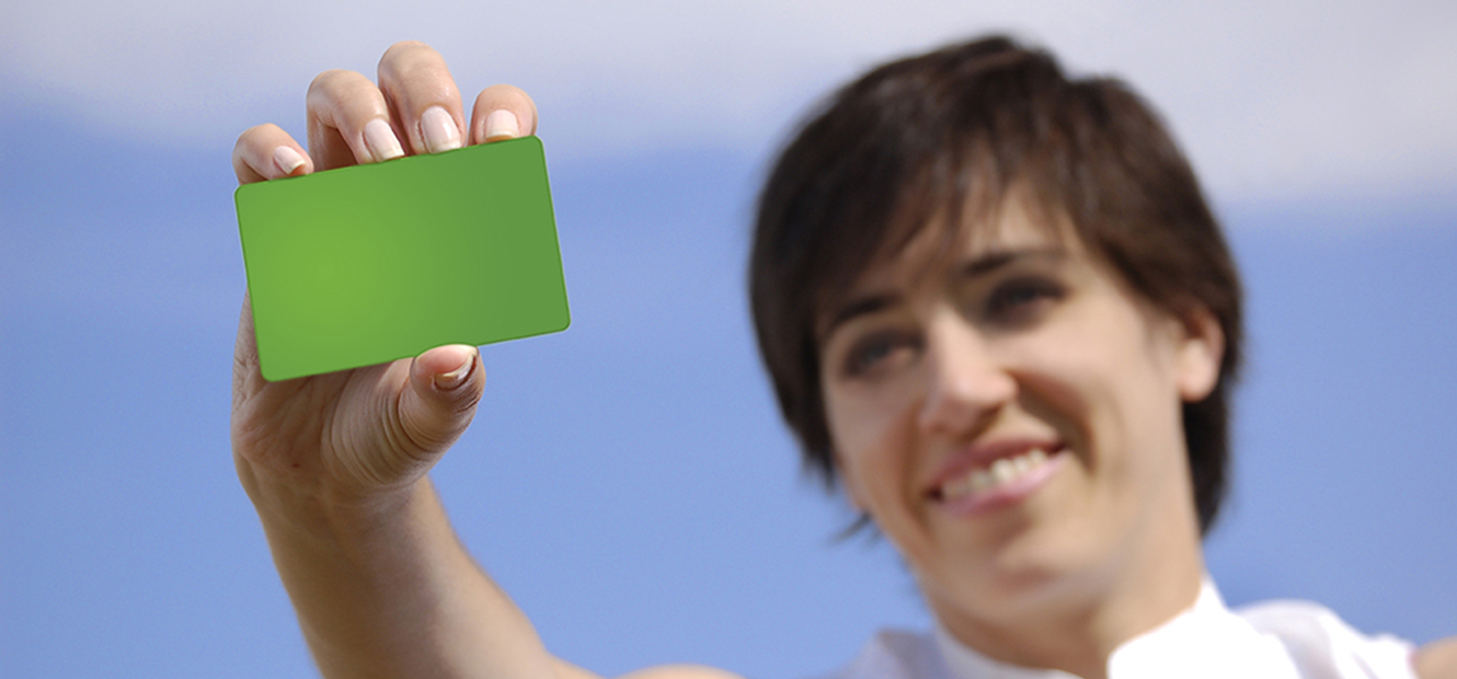 Green Giving Checking account. Woman holding green debit card