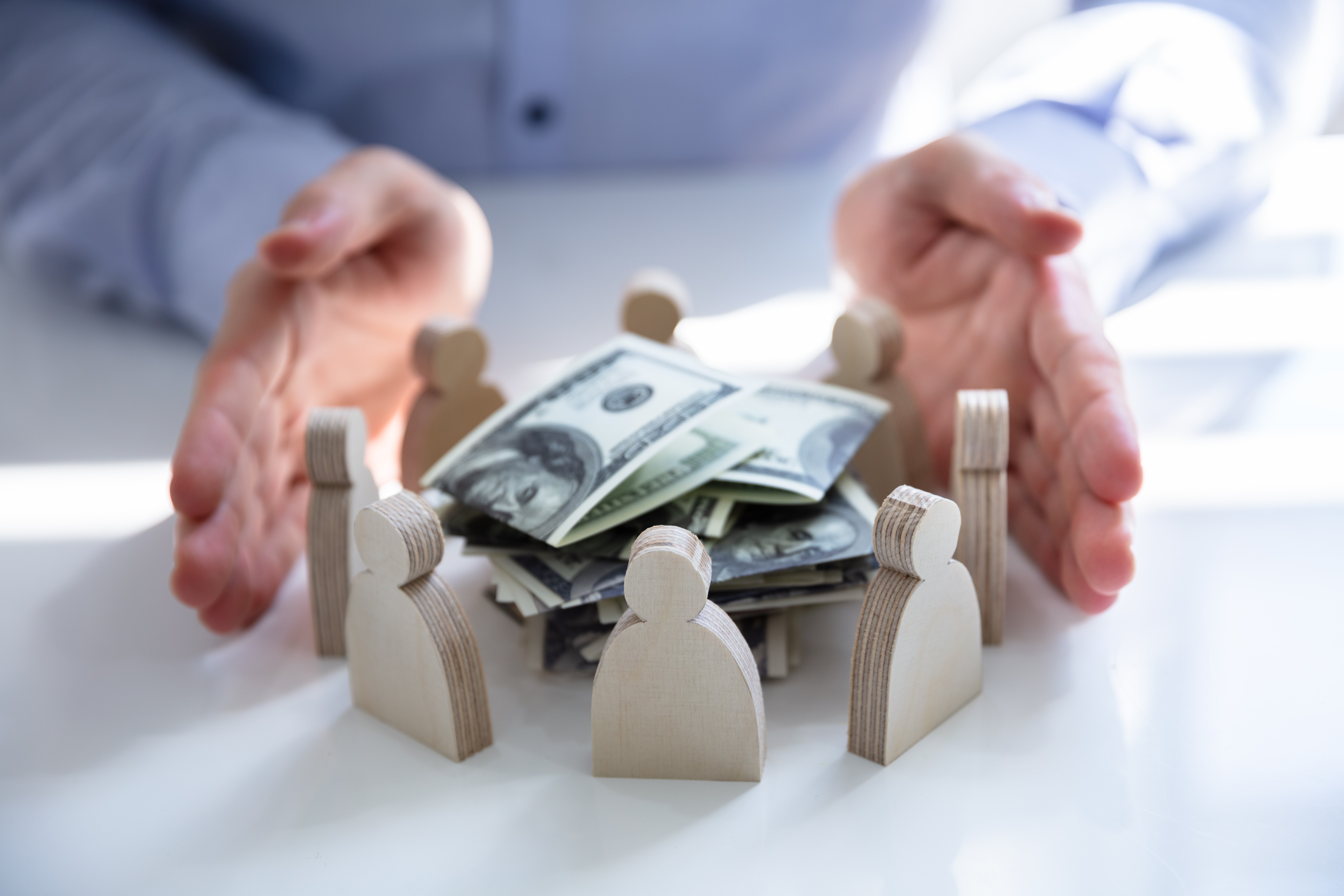 money pile wooden people